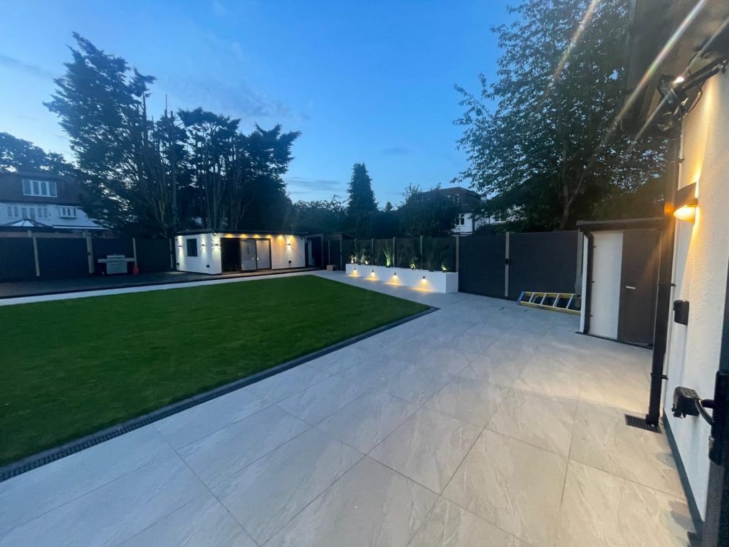 Lawn and patio at dusk - VED Construction